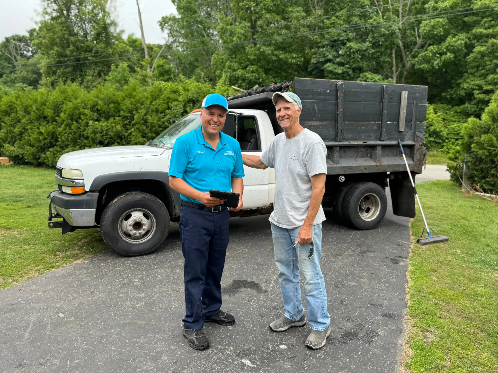 Dante, owner of Family Cleanout Junk Removal LLC, speaking with a customer at a job in Eastern Connecticut