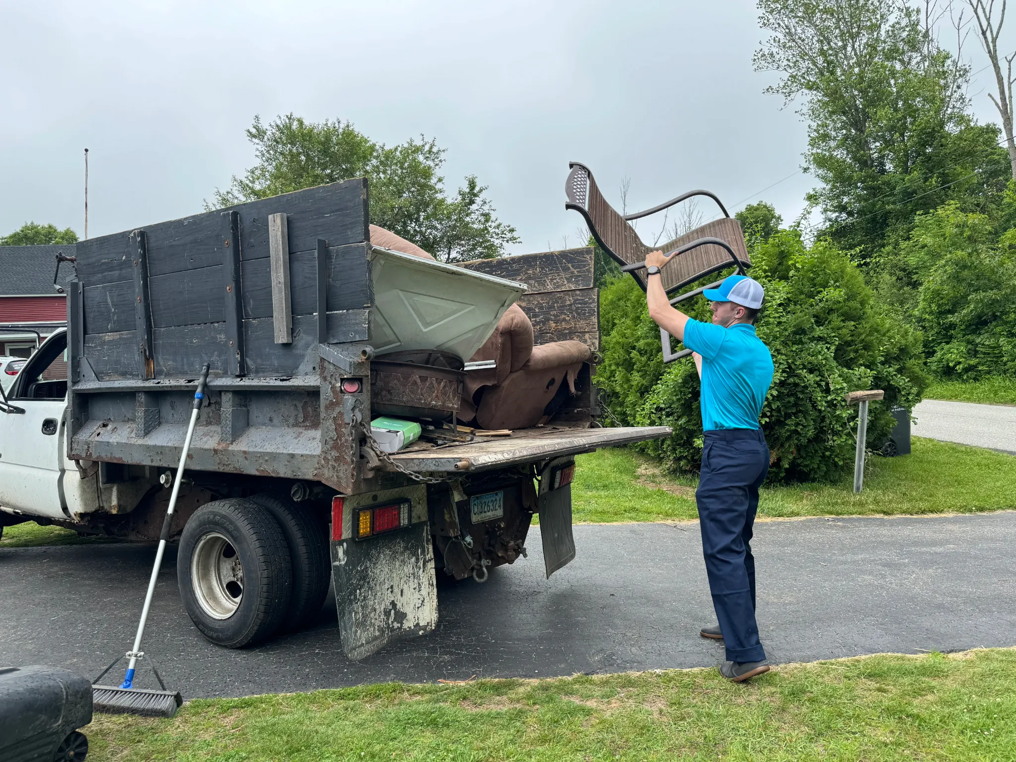 Family Cleanout Junk Removal crew loading truck for a job in Griswold and Jewett City, CT